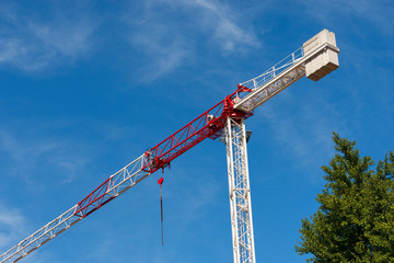 Red and White Crane on Blue Sky with Clouds