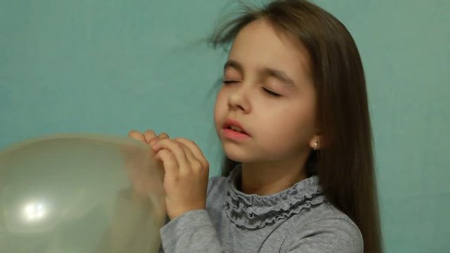 Girl inflates and blows away balloon