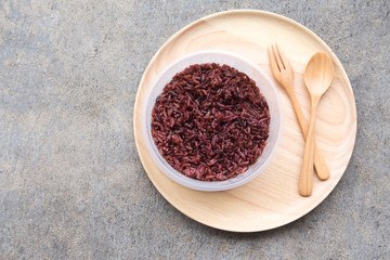 Cooked rice berry (purple rice) on wooden plate