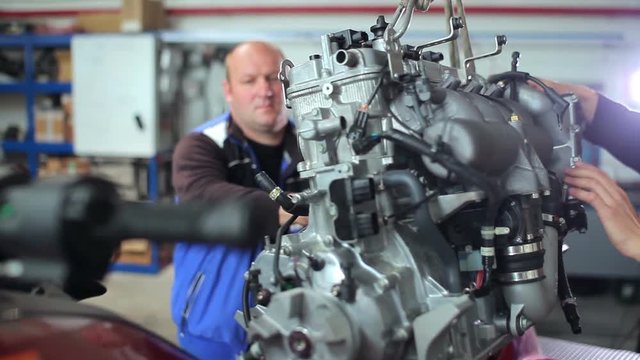 Repairers work on the engine at the yacht centre