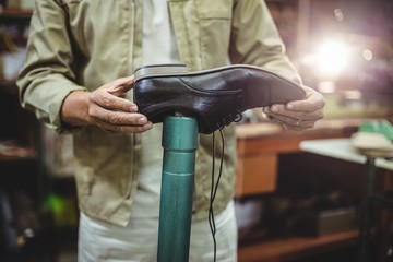 Shoemaker repairing a shoe