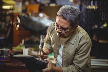 Shoemaker hammering on a shoe