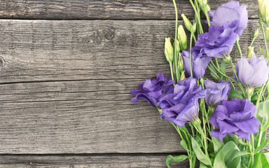 Bouquet of purple flower lisianthus on rustic wooden background