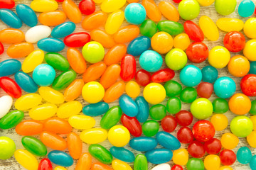 Colorful jelly beans close to wallpaper