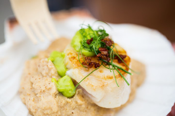 close up of scallop snack with garnish