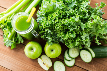 close up of jug with green juice and vegetables