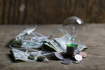 coins and crumpled money tungsten lamp filament