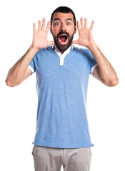 Man with blue shirt doing surprise gesture