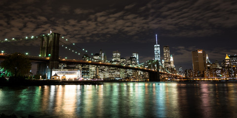 Brooklyn Bridge in front of Manhattan at night