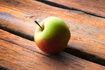 Wild apple on wooden table