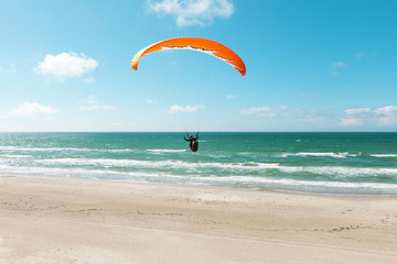 Paragliding on the deserted beach