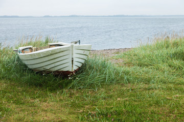 Fototapeta na wymiar Boat aground on the lawn