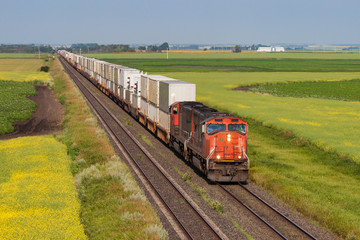 Container train across green and yellow prairie