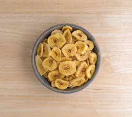 Dried bananas in an old bowl on a table top view.