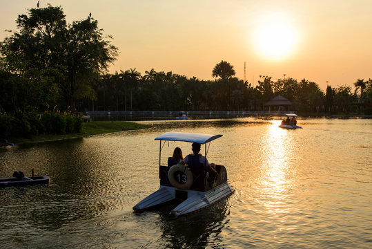 Couble in pedal boat at sunset