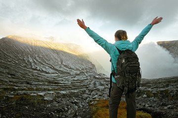Woman with backpacker enjoying view at top volcano Ijen. Indonesia. © soft_light