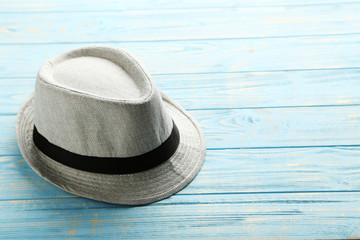 Pretty white hat on a blue wooden table