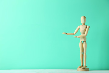 Wooden figure on a green wooden table