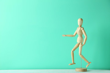 Wooden figure on a green wooden table