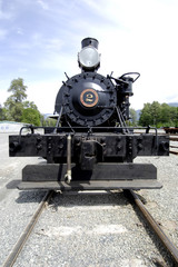 Obraz na płótnie Canvas Steam engine from front with tracks
