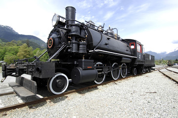 Fototapeta na wymiar No 2 Steam Engine left side full on tracks with blue sky