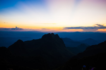 Mountain silhoette of sub alpine at sunrise glowing sky