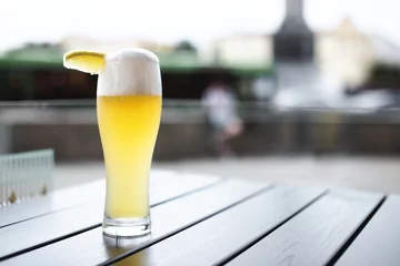 Foto op Canvas Wheat beer with slice of lemon on table © eugenegg