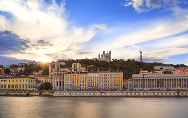 Colorful sunset at Vieux Lyon and Fourviere Basilica seen from the riverbank of the Saone, Lyon.
