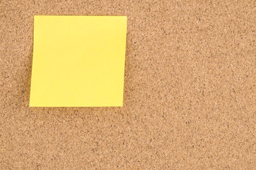 Cork Noticeboard with a Blank Sticky Note