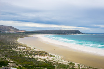 The scenic Noordhoek beach with dramatic sky in winter. Panoramic view from Chapman's Peak Drive, Cape Peninsula, Cape Town, South Africa.