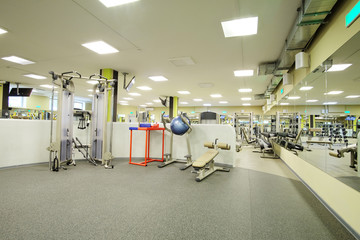 Fototapeta premium Interior of a fitness hall with sport equipment