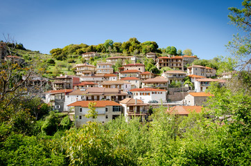 Fototapeta na wymiar House and cemetery on the top of the hill, Baltessiniko village. Arcadia, Peloponnese,Greece