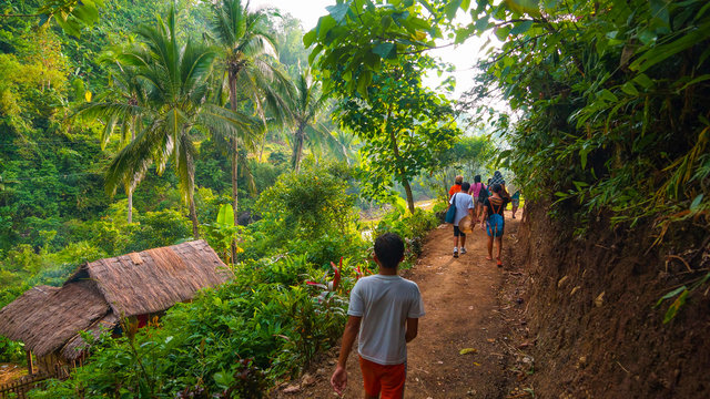 Local village hikers on lush jungle trail - Panay, Philippines