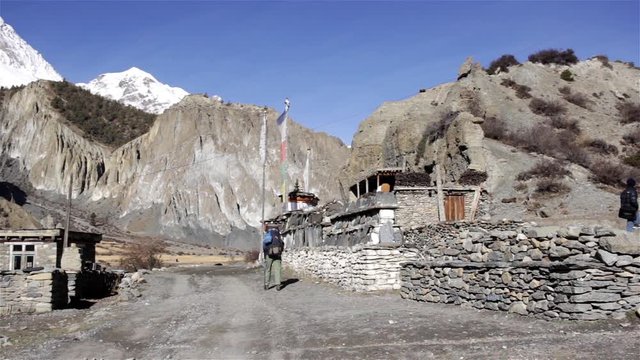 Hiker walking near religious stones with scriptures