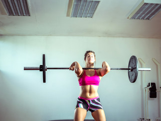 Fototapeta na wymiar Girl doing weightlifting