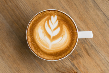 A Latte Coffee art on the wooden desk