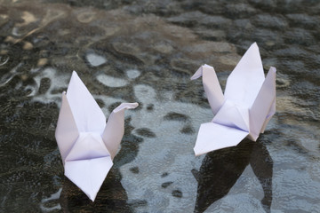 white origami bird on glass table