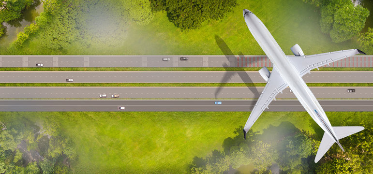 Top view of airplane flying over the roads