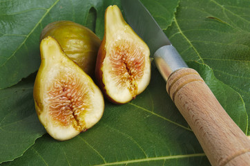 Fresh fig fruits on a wooden table with knife. Nutrition and healthy lifestyles