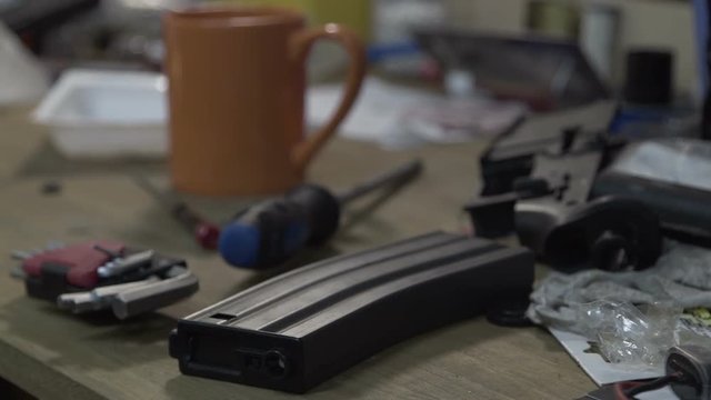 The table with tools. Place in a workshop for repair of weapons. Broken clips for ammunition.
