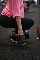 Fototapeta na wymiar Woman at the fitness gym exercising