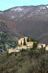 Fototapeta na wymiar Rocca Sinibalda (Rieti, Italy) with the famous medieval castle, in a winter day, with snowy peaks