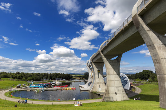 Falkirk Wheel with blue sky in Falkirk Scotland. The Wheel is a rotating boat lift connecting the Forth and Clyde Canal with the Union Canal
