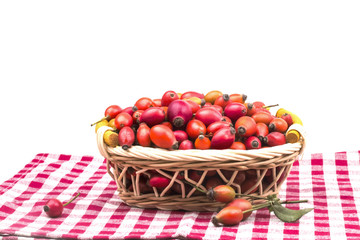 on a table full of young basket of ripe red wild rose hips