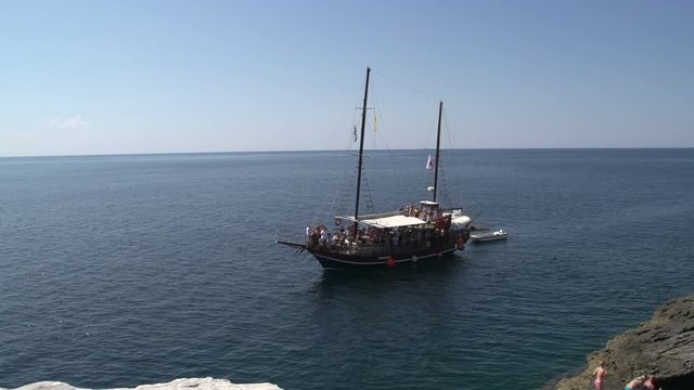 Junk sailboat passing by giola in Thassos Greece