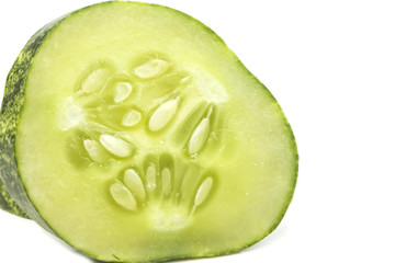 one cut piece of cucumber seeds with detail close