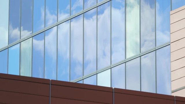 Clouds reflected in glass of modern blue building
(Filmed in ProRes with high dynamic range for flexibility for image grading)