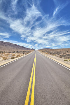 Desert road in Death Valley, travel concept.