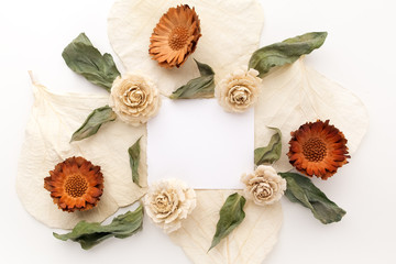 Framework with dry flowers on white background. Flat lay, overhead view