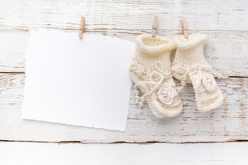 New Born or baptism Greeting Card. Blank with baby girl shoes on white wooden background